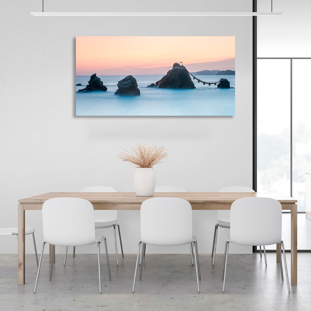 5 rocks in the sea with two mountains in the background Canvas Wall Art Print