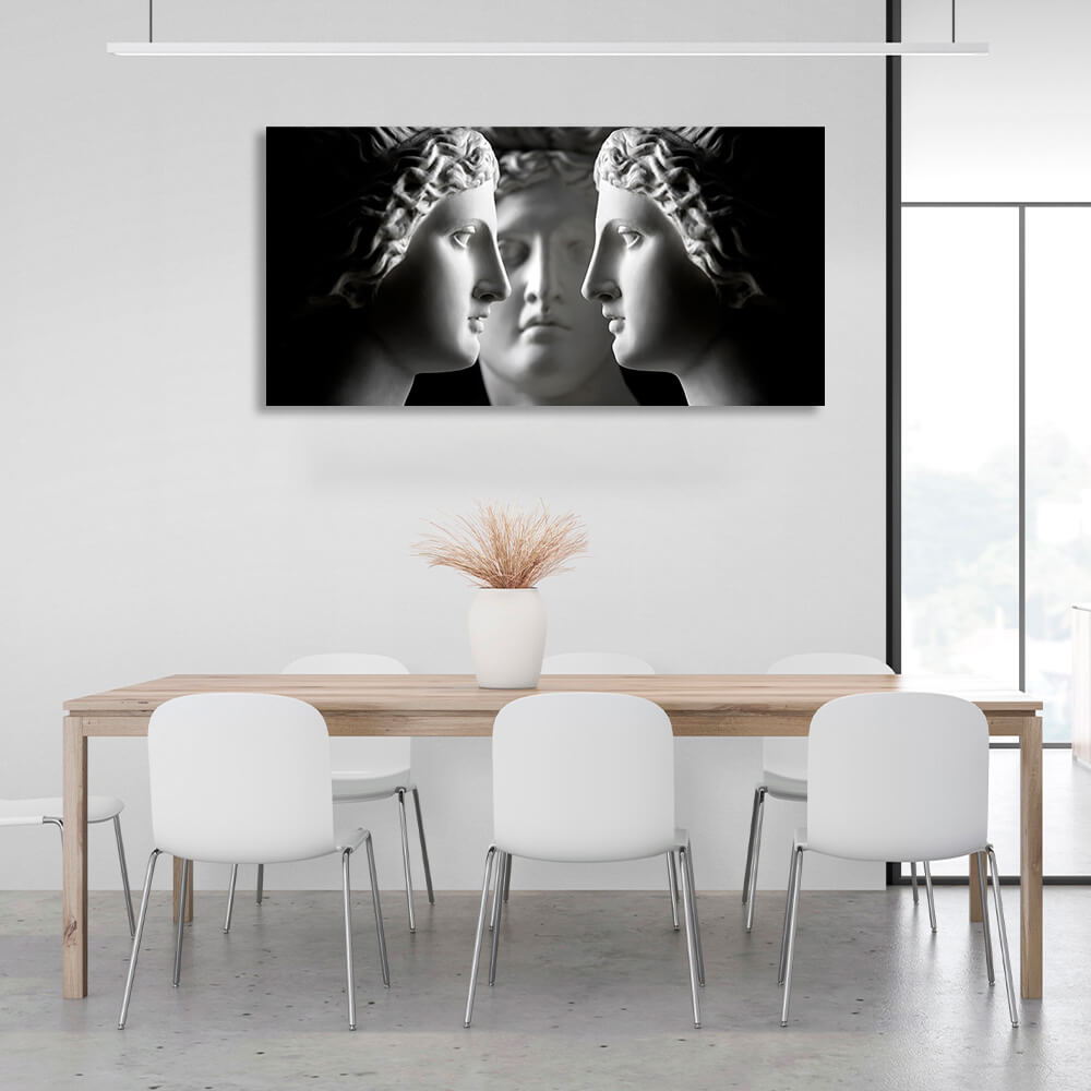 Three antique sculptures on a black background Canvas Wall Art Print