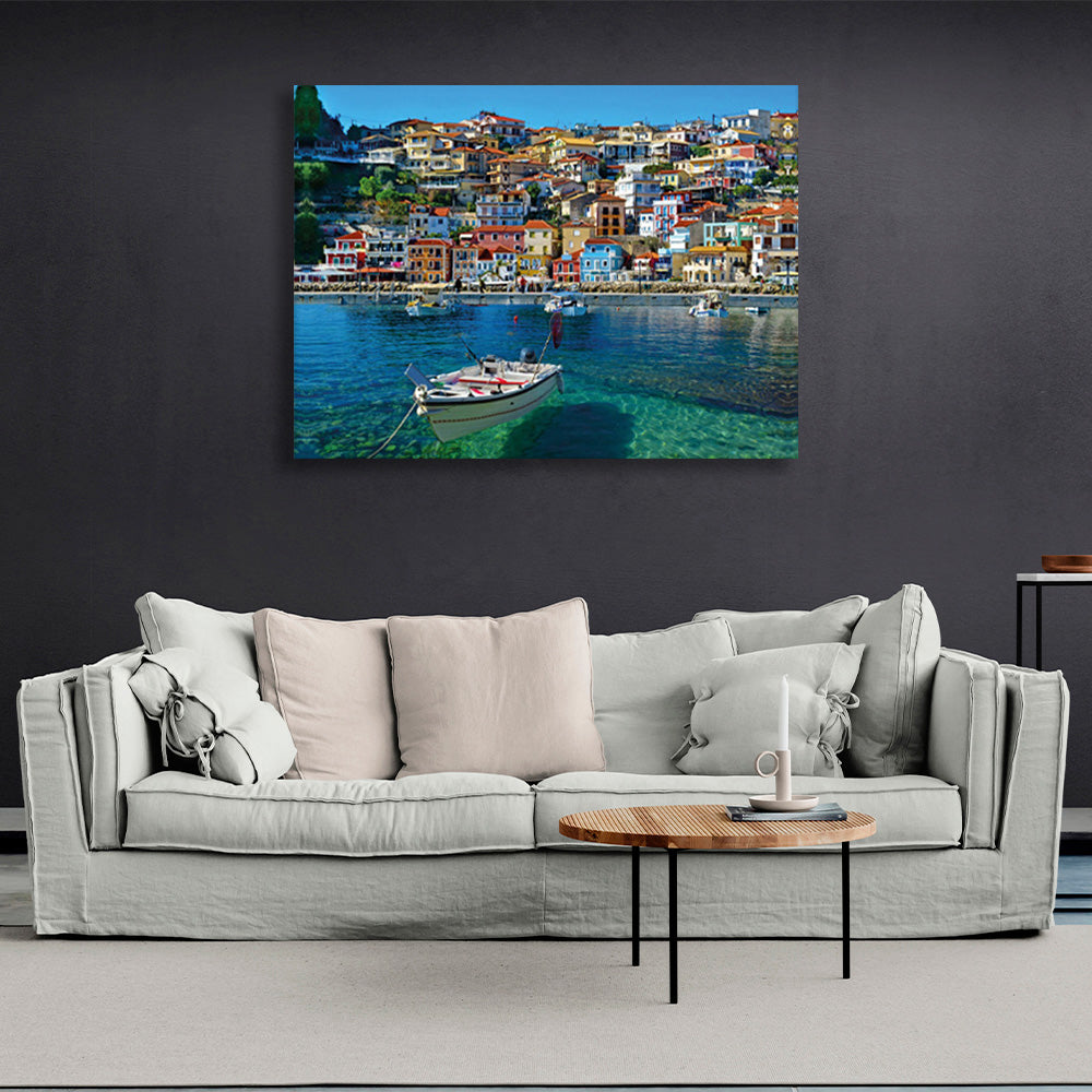 A boat in an incredibly clear sea against the backdrop of a brightly colored city Canvas Wall Art Print