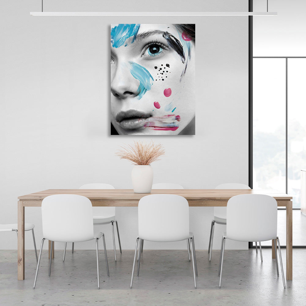 A girl with black eyes with smears of paint on her face Canvas Wall Art Print